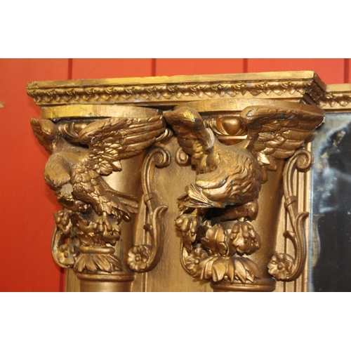 330 - Giltwood overmantle mirror flanked by four pillars and surmounted with eagles {H 140cm x W 196cm }. ... 