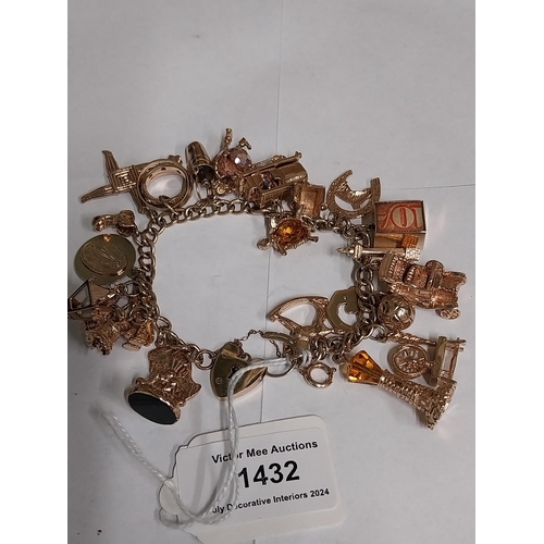 1432 - 9 ct. gold bracelet with twenty four charms. Wt : 75grams approx.