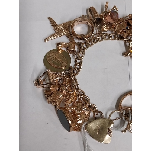 1432 - 9 ct. gold bracelet with twenty four charms. Wt : 75grams approx.