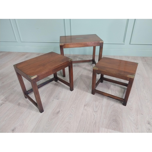 129 - Good quality mahogany and brass nest of three tables in the campaign style raised square legs {50 cm... 