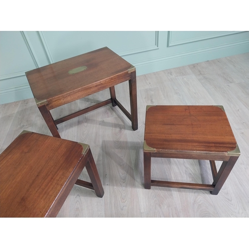 129 - Good quality mahogany and brass nest of three tables in the campaign style raised square legs {50 cm... 