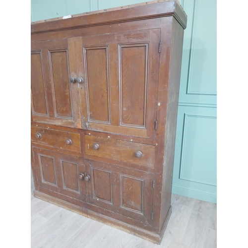 213 - 19th C. Irish scumbled pine kitchen cupboard with two panelled doors and two short drawers over two ... 