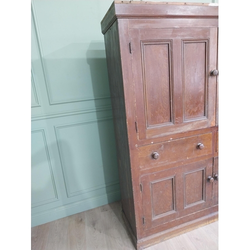 213 - 19th C. Irish scumbled pine kitchen cupboard with two panelled doors and two short drawers over two ... 