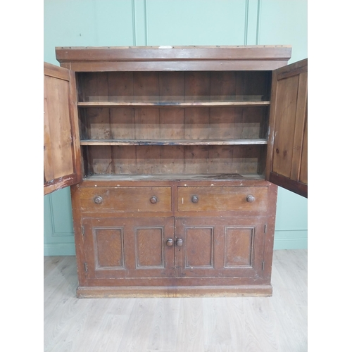 213 - 19th C. Irish scumbled pine kitchen cupboard with two panelled doors and two short drawers over two ... 