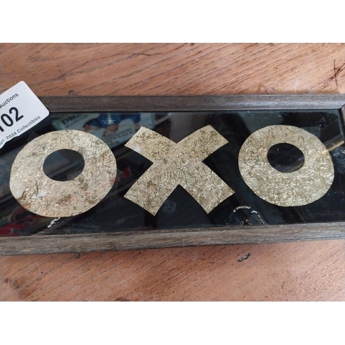 102 - Framed OXO on glass framed advertisement. {13 cm H x 33 cm W}