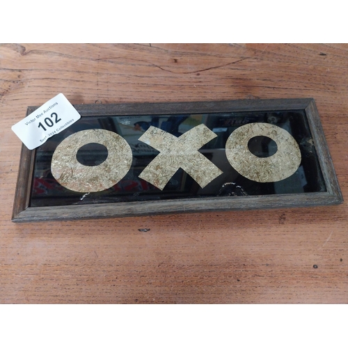 102 - Framed OXO on glass framed advertisement. {13 cm H x 33 cm W}