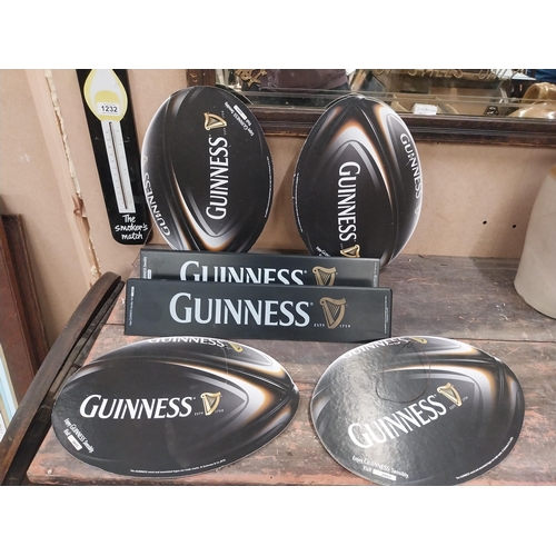 1252 - Two Guinness counter signs {9 cm H x 44 cm W} and four Guinness Rugby advertising signs. {24 cm H x ... 