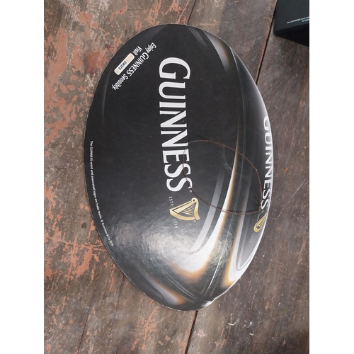 1252 - Two Guinness counter signs {9 cm H x 44 cm W} and four Guinness Rugby advertising signs. {24 cm H x ... 