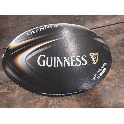 1252 - Two Guinness counter signs {9 cm H x 44 cm W} and four Guinness Rugby advertising signs. {24 cm H x ... 