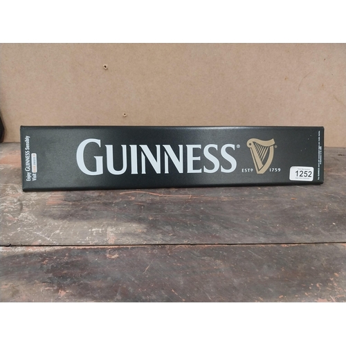 1252 - Two Guinness counter signs {9 cm H x 44 cm W} and four Guinness Rugby advertising signs. {24 cm H x ... 