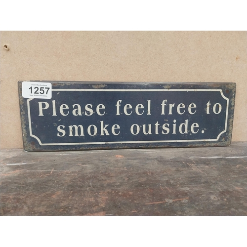 1257 - Please feel free to smoke outside tinplate sign. {10 cm H x 41 cm W}.