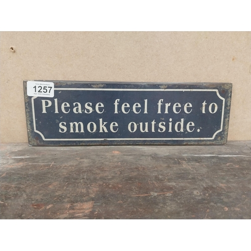 1257 - Please feel free to smoke outside tinplate sign. {10 cm H x 41 cm W}.