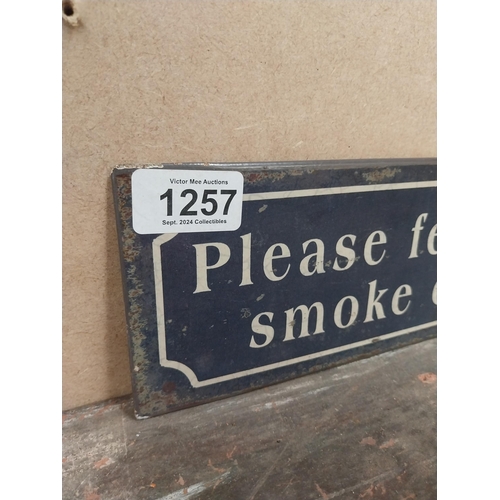 1257 - Please feel free to smoke outside tinplate sign. {10 cm H x 41 cm W}.