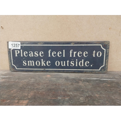 1257 - Please feel free to smoke outside tinplate sign. {10 cm H x 41 cm W}.