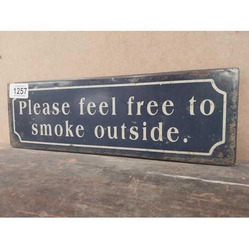 1257 - Please feel free to smoke outside tinplate sign. {10 cm H x 41 cm W}.