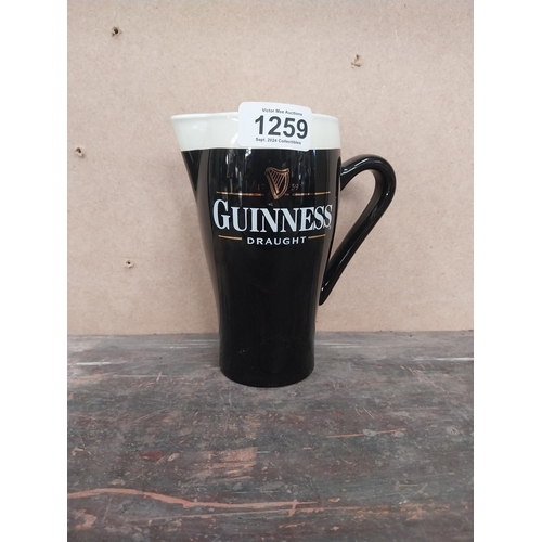 1259 - Guinness Draught ceramic advertising jug. {16 cm H x 15 cm W x 8 cm D}.