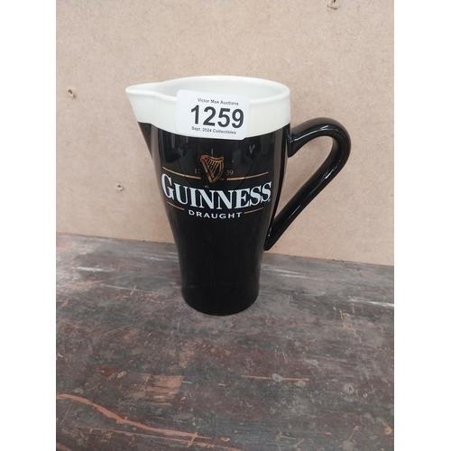 1259 - Guinness Draught ceramic advertising jug. {16 cm H x 15 cm W x 8 cm D}.