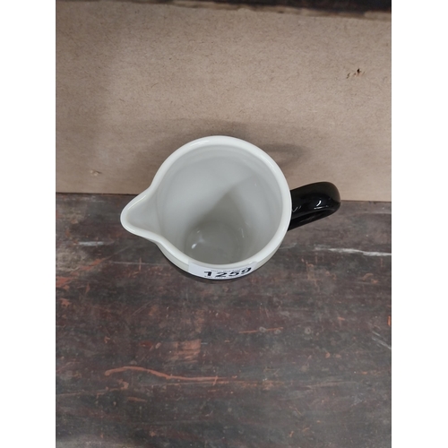 1259 - Guinness Draught ceramic advertising jug. {16 cm H x 15 cm W x 8 cm D}.