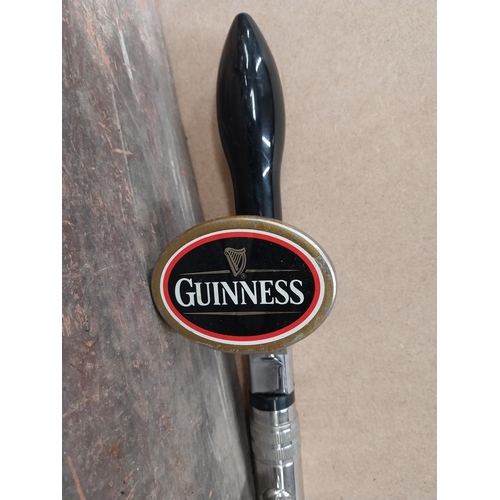 1282 - Three Guinness bar pulls and drip tray. {34 cm H x 26 cm W}.