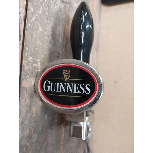 1282 - Three Guinness bar pulls and drip tray. {34 cm H x 26 cm W}.