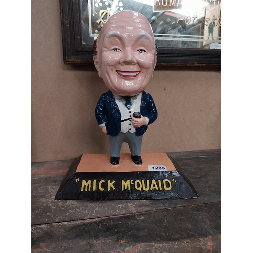 1288 - Mick McQuaid composition advertising figure. {36 cm H x 28 cm W x 17 cm D}.