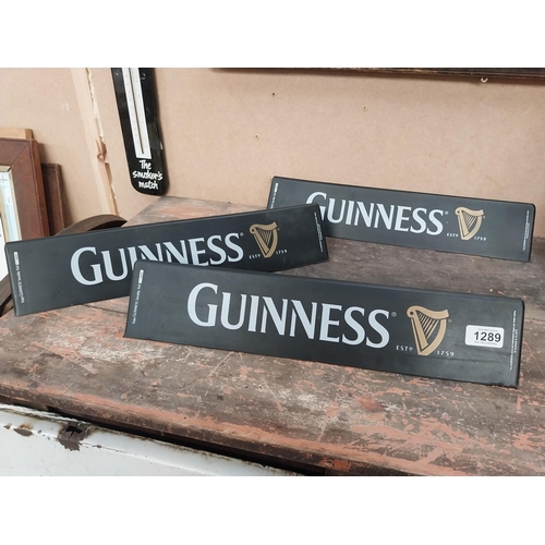 1289 - Three Guinness counter signs. {9 cm H x 45 cm W}.