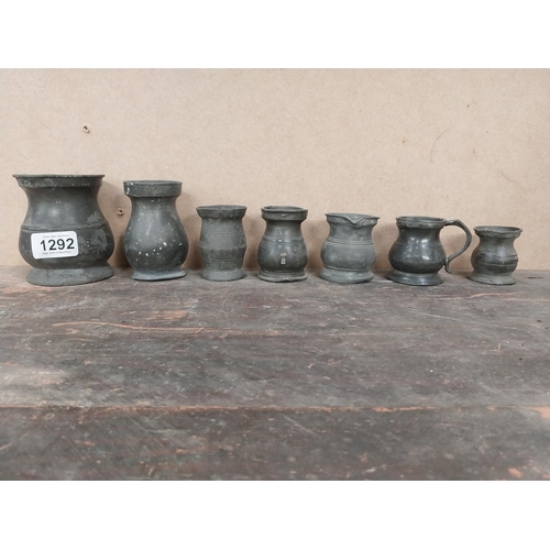 1292 - Seven early 19th C. pewter whiskey measures. {10 cm H x 8 cm Diam to 5 cm W x 4 cm Diam.}.