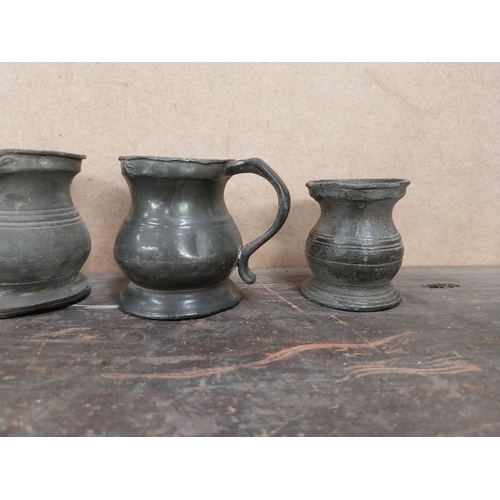 1292 - Seven early 19th C. pewter whiskey measures. {10 cm H x 8 cm Diam to 5 cm W x 4 cm Diam.}.