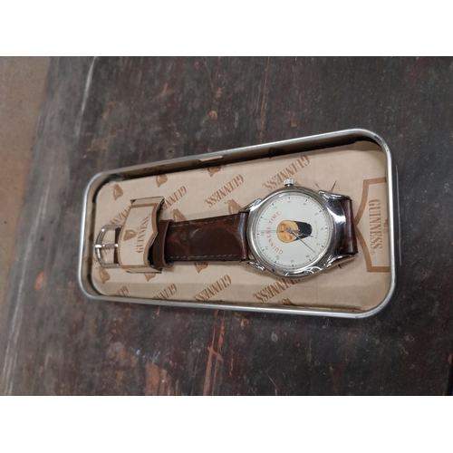 1296 - Guinness advertising watch in tin presentation case.