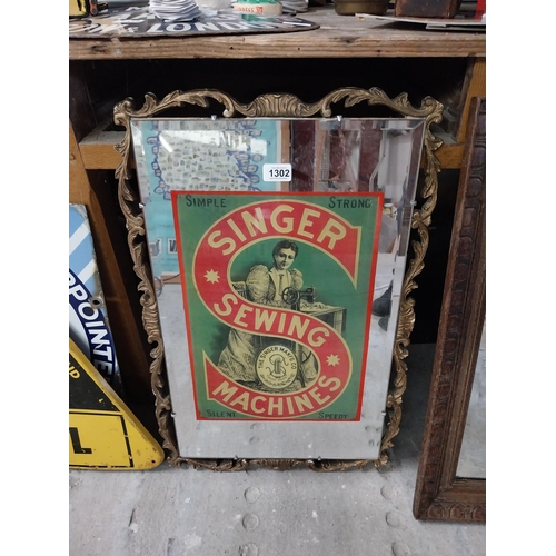 1302 - Singer Sewing Machines advertising mirror in gilt frame. {64 cm H x 45 cm W}.