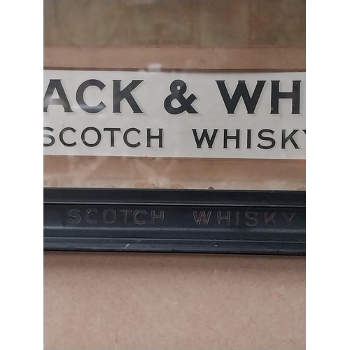 1309 - Buchanan's Black and White Scotch Whiskey showcard in original frame. {52 cm H x 44 cm W}.