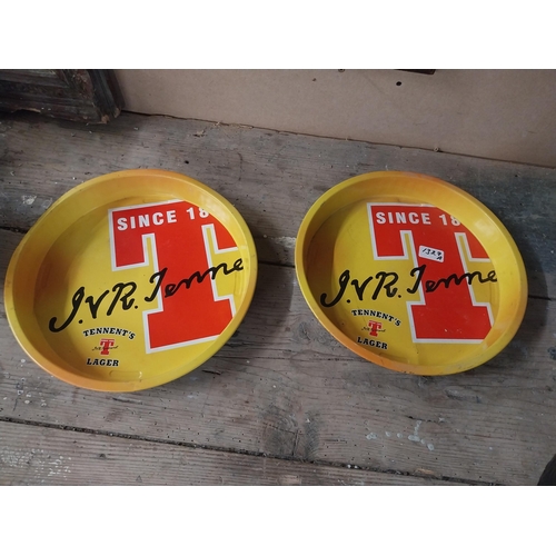 1327A - Two Tennent's Lager tinplate drinks' trays. { 33cm Dia }.