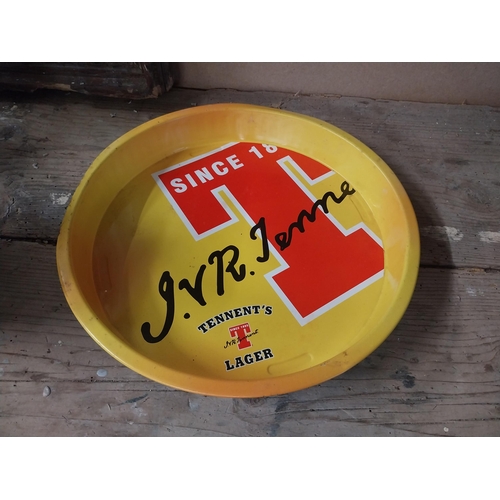 1327A - Two Tennent's Lager tinplate drinks' trays. { 33cm Dia }.