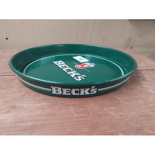 142 - Beck's Lager {33 cm Diam.} and Truman's Beer and Ale  {32 cm H x 41 cm W} tin plate advertising tray... 