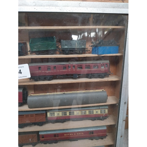 144 - Cased collection of 1950's railway carriages and engines.  {62 cm x 58 cm W x 8 cm D}.