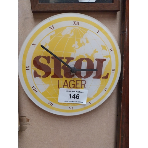 146 - SKOL Perspex advertising battery clock. {20 cm H x 22 cm W}.