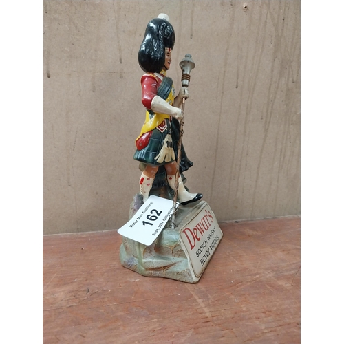 162 - Dewar's Scotch Whiskey Ruberoid advertising figure. {24 cm H x 11 cm W x 8 cm D}.