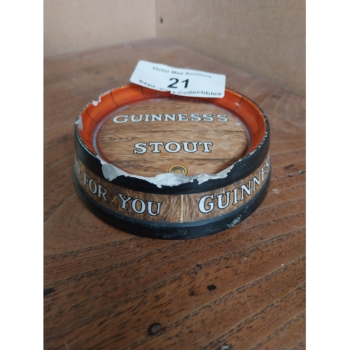 21 - Guinness ceramic ashtray in form of barrel top. {4 cm H x 13 cm Diam.}.