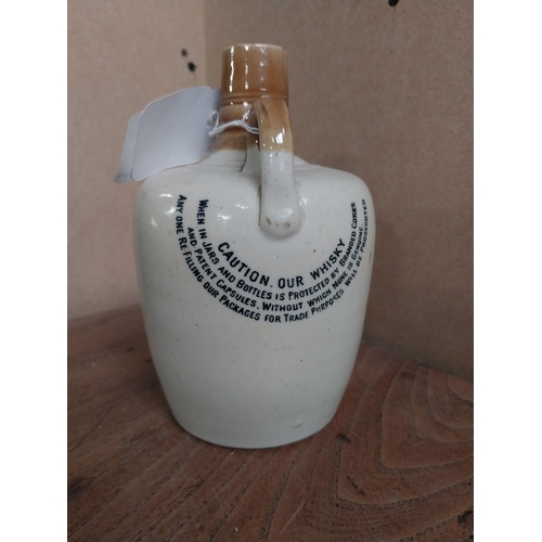 22 - 19th C. Cruiskeen Lawn Old Irish Whiskey stoneware flagon. {19 cm H x 11 cm W x 11 cm D}.