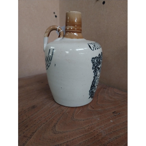 22 - 19th C. Cruiskeen Lawn Old Irish Whiskey stoneware flagon. {19 cm H x 11 cm W x 11 cm D}.