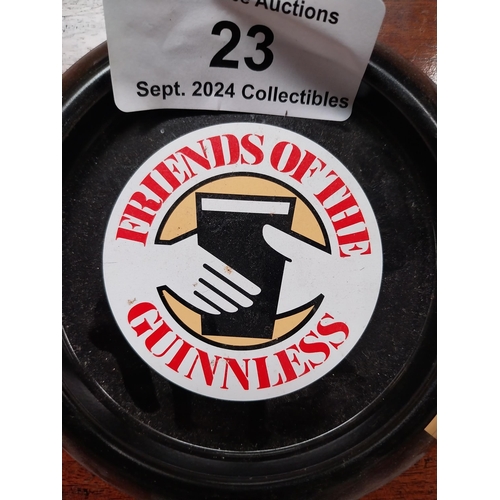 23 - Three tin plate Friends of the Guinnless advertising ashtrays {3 cm H x 15 cm Diam.}.