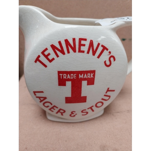 76 - Tennents Lager and Stout ceramic advertising water jug. {12 cm H x 16 cm W x 9 cm D}