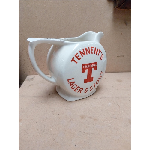 76 - Tennents Lager and Stout ceramic advertising water jug. {12 cm H x 16 cm W x 9 cm D}