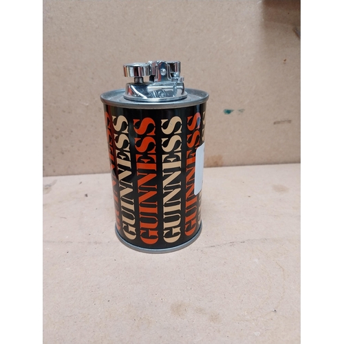 77 - Guinness tin plate Cigarette lighter in original box. {12 cm H x 7 cm Diam.}.