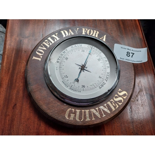 87 - Lovely Day for a Guinness wooden advertising barometer. {5 cm H x 20 cm Diam.}.