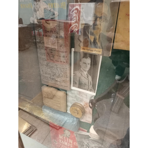 1315 - Wartime glazed showcase featuring gasmask, light , field dressings, books , old photos, etc  {H 756c... 