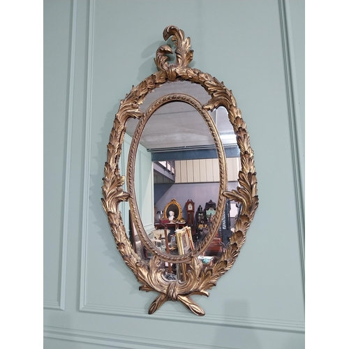 1041 - Good quality gilt wall mirror in the Rococo style. {132 cm W x 70 cm W}.