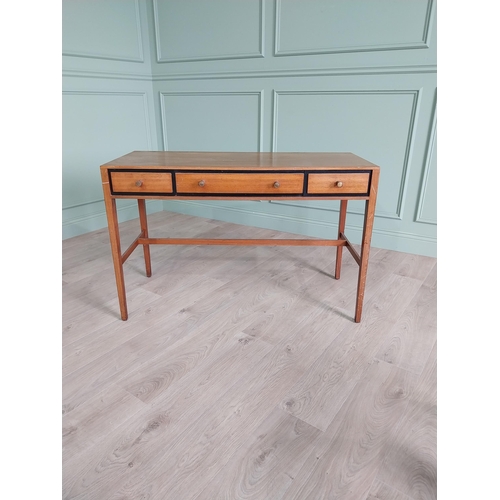 1133 - Mid-century teak desk with three drawers raised on square tapered legs and single stretcher {75 cm H... 