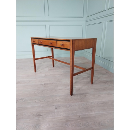 1133 - Mid-century teak desk with three drawers raised on square tapered legs and single stretcher {75 cm H... 