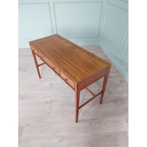 1133 - Mid-century teak desk with three drawers raised on square tapered legs and single stretcher {75 cm H... 